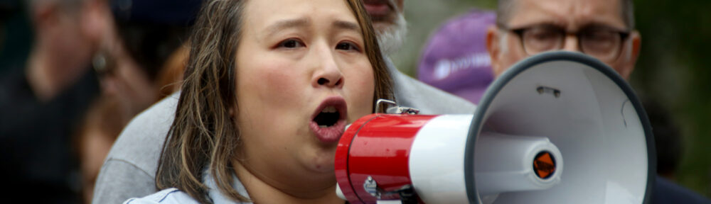 Yuh-Line Niou speaks into a bullhorn at the Free Brad Lander Rally in Foley Square