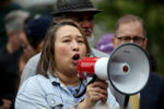 Yuh-Line Niou speaks into a bullhorn at the Free Brad Lander Rally in Foley Square