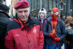 Curtis Sliwa smiles at the camera at Fulton and Broadway after the inauguration. A person dressed as Spider-Man stands behind him.