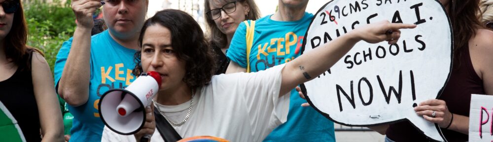 Ilana Glazer speaks into a bullhorn at the A.I. Moratorium for NYC Schools rally in NYC, City Hall, on 6/9/2026.
