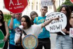 Ilana Glazer speaks into a bullhorn at the A.I. Moratorium for NYC Schools rally in NYC, City Hall, on 6/9/2026.